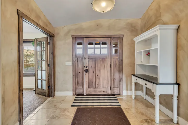 Foyer featuring vaulted ceiling and healthy amount of natural light