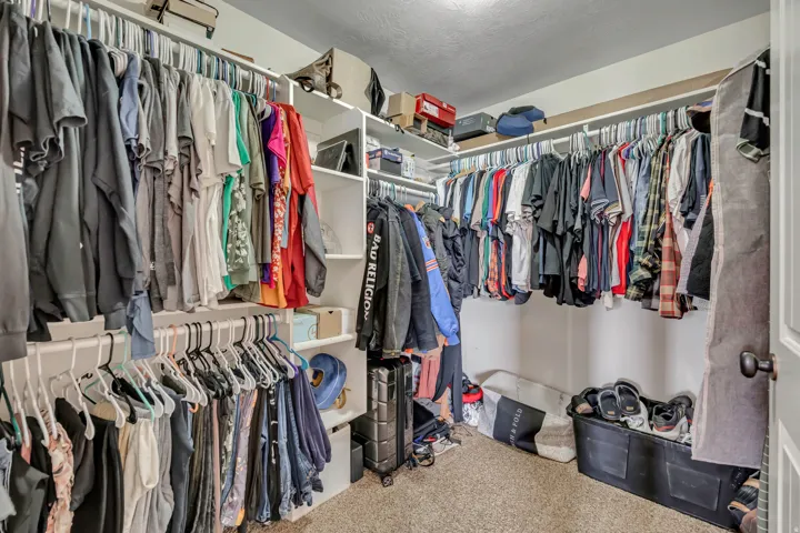 Walk in closet featuring carpet flooring
