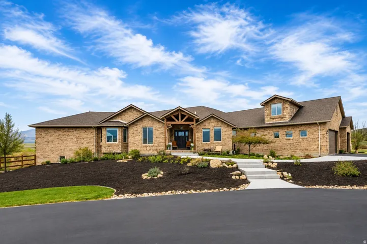 Expansive ranch-style residence featuring a brick exterior and a multi-level roofline