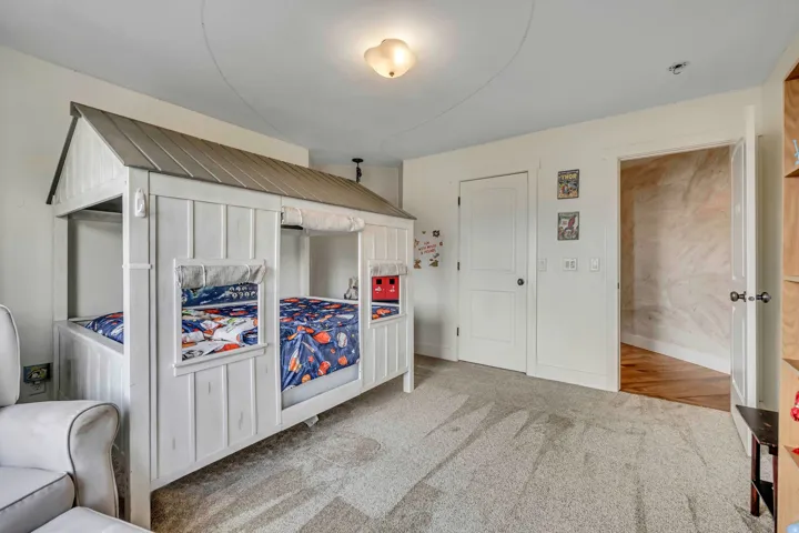 Bedroom featuring light colored carpet