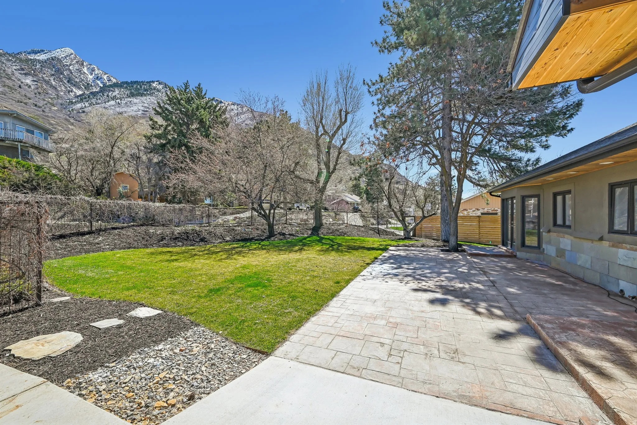 Fenced backyard featuring a mountain view and a patio