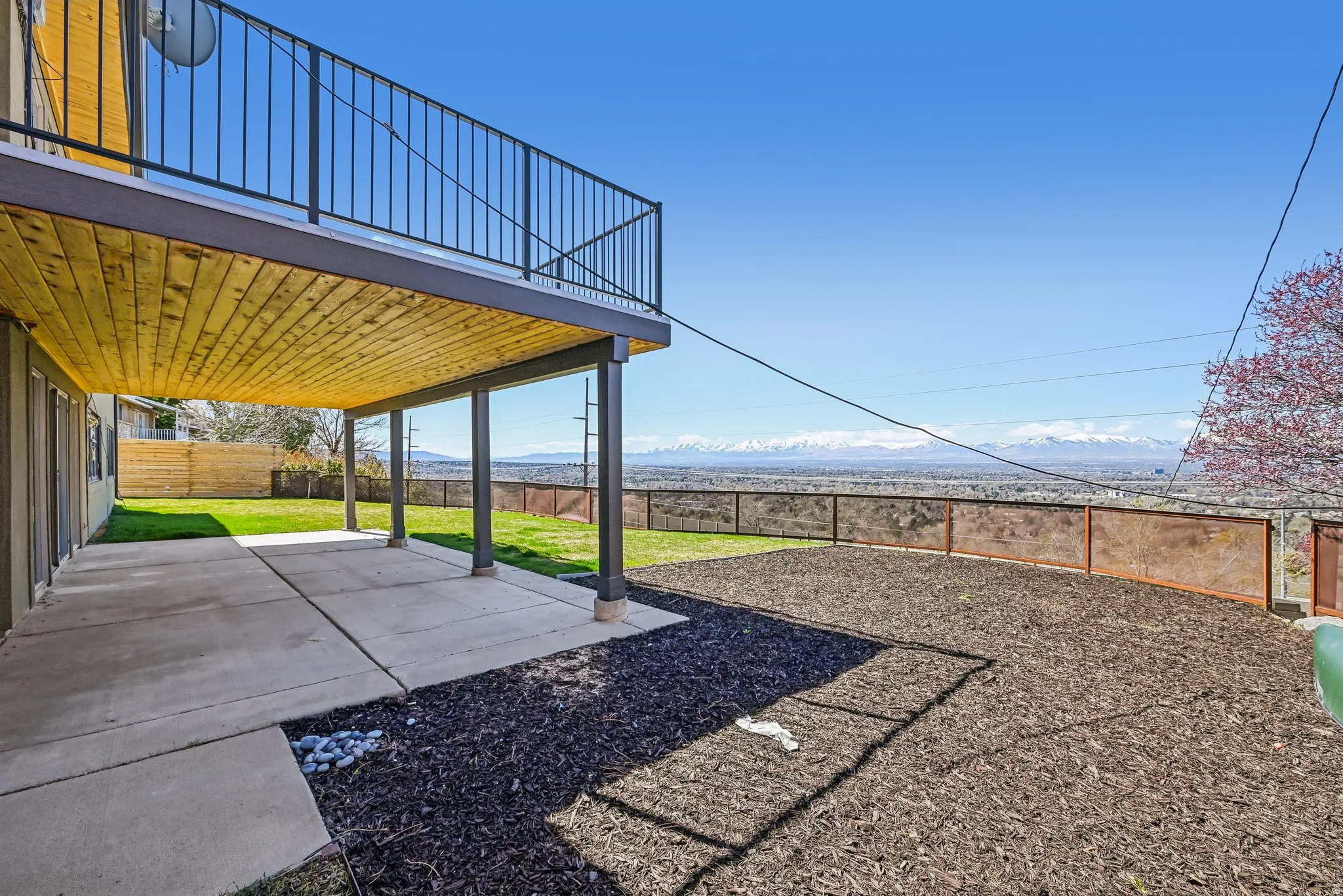 Back deck and lower patio from walk out basement.  Views of the city and Oquirrh Mountain Range