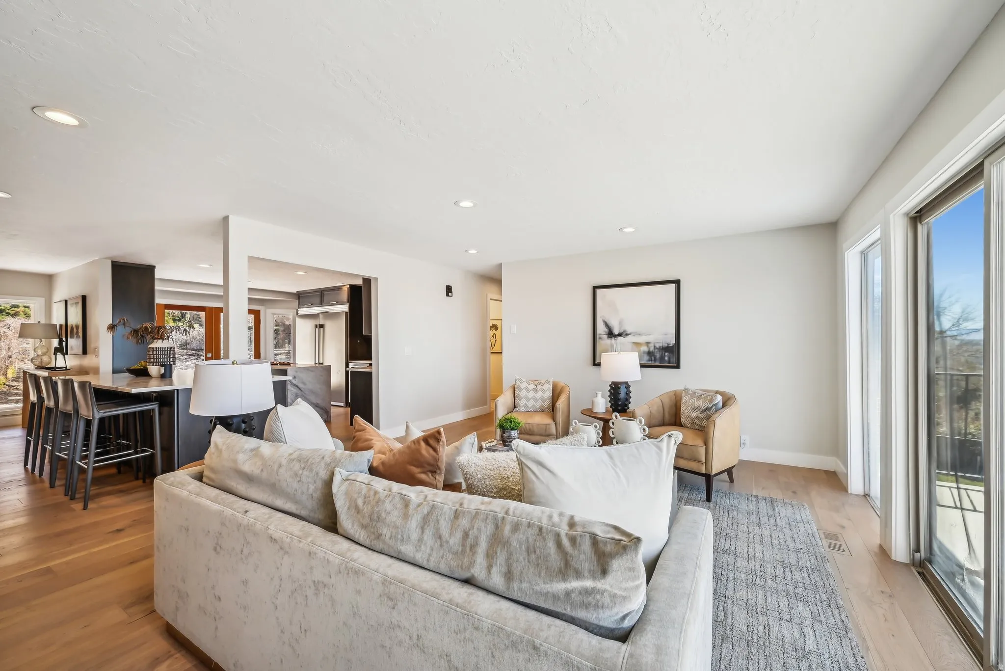 Living area featuring light wood-style flooring and recessed lighting