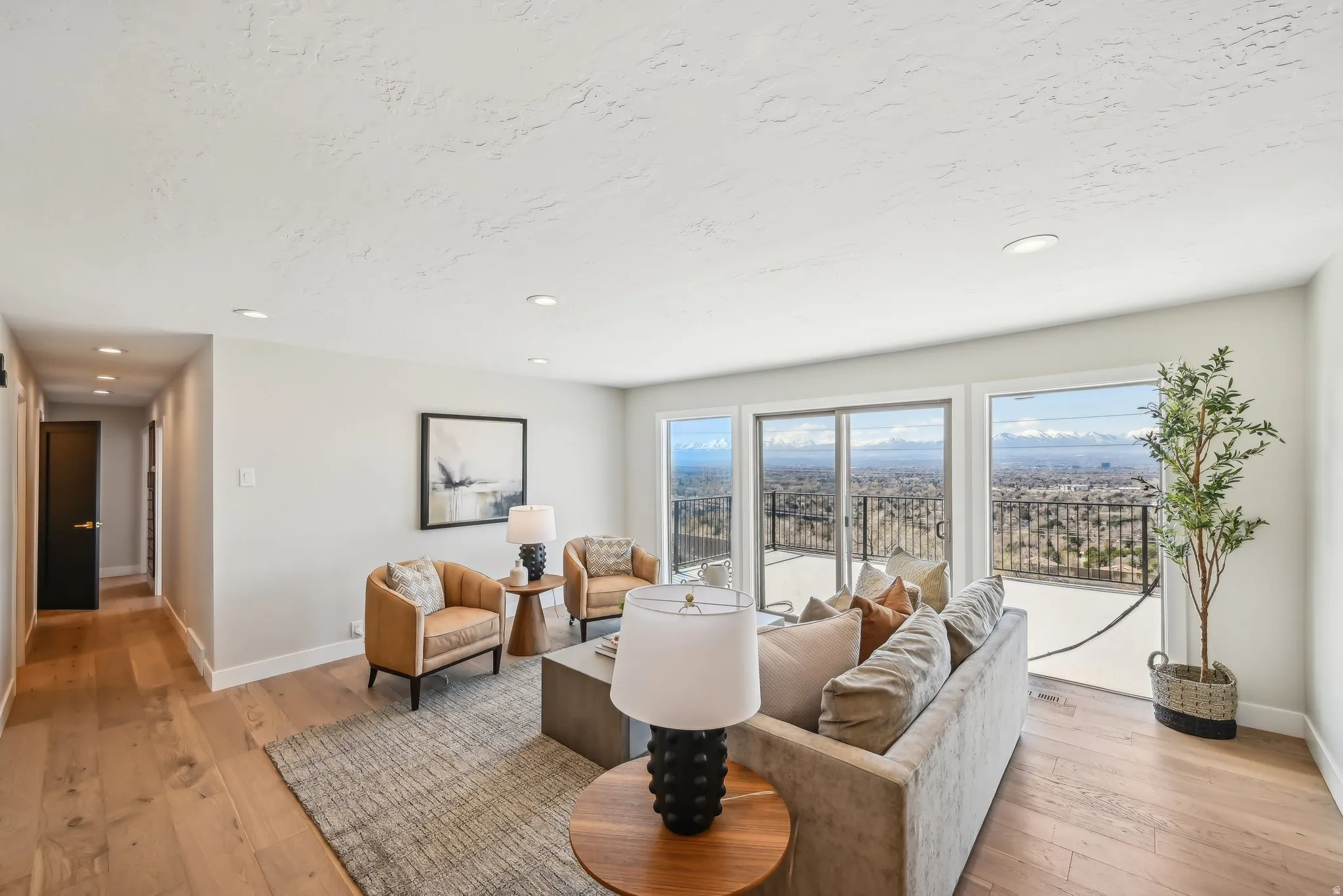 Living area with light wood-style floors and recessed lighting
