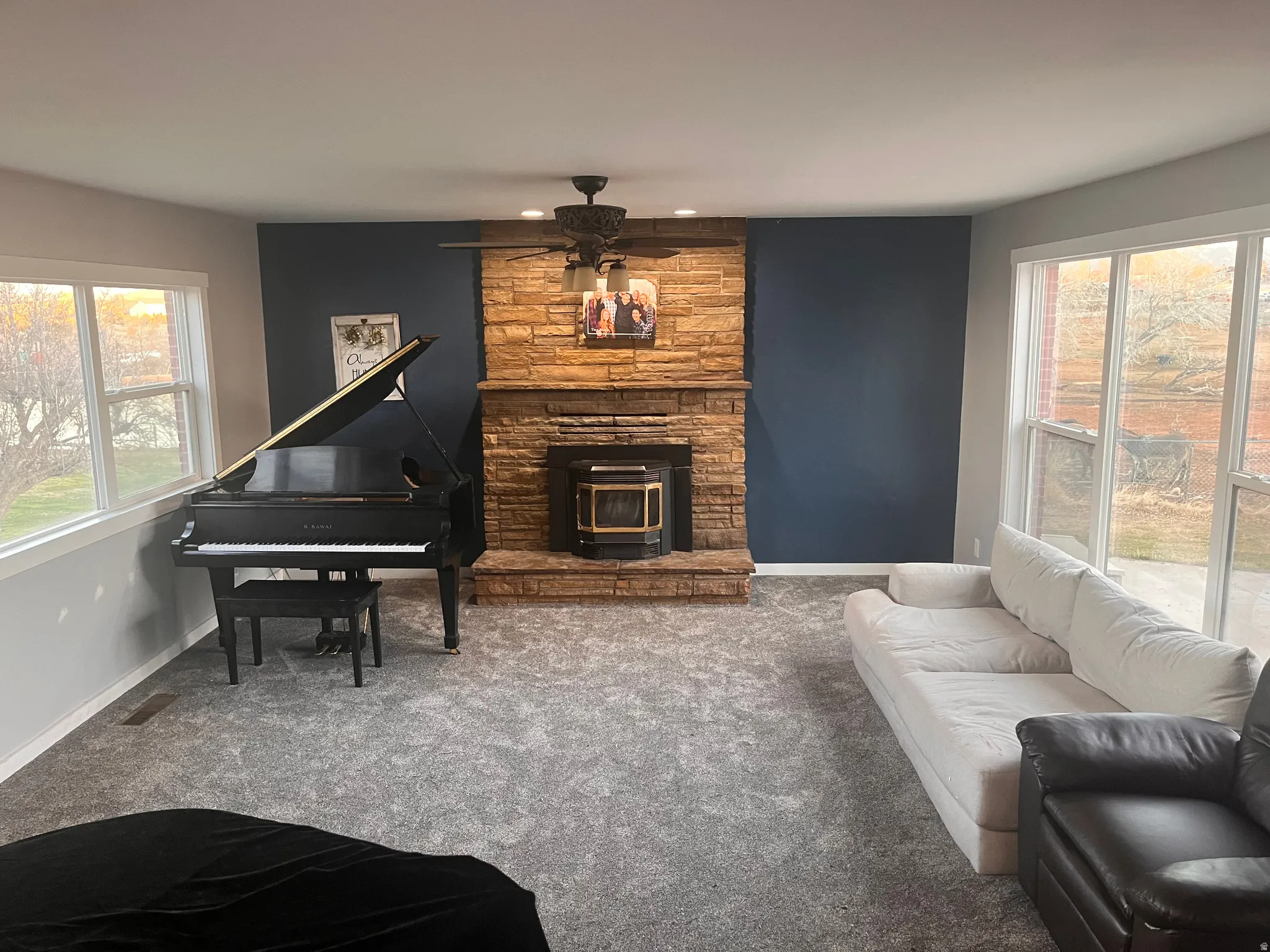 Living room with ceiling fan and carpet floors