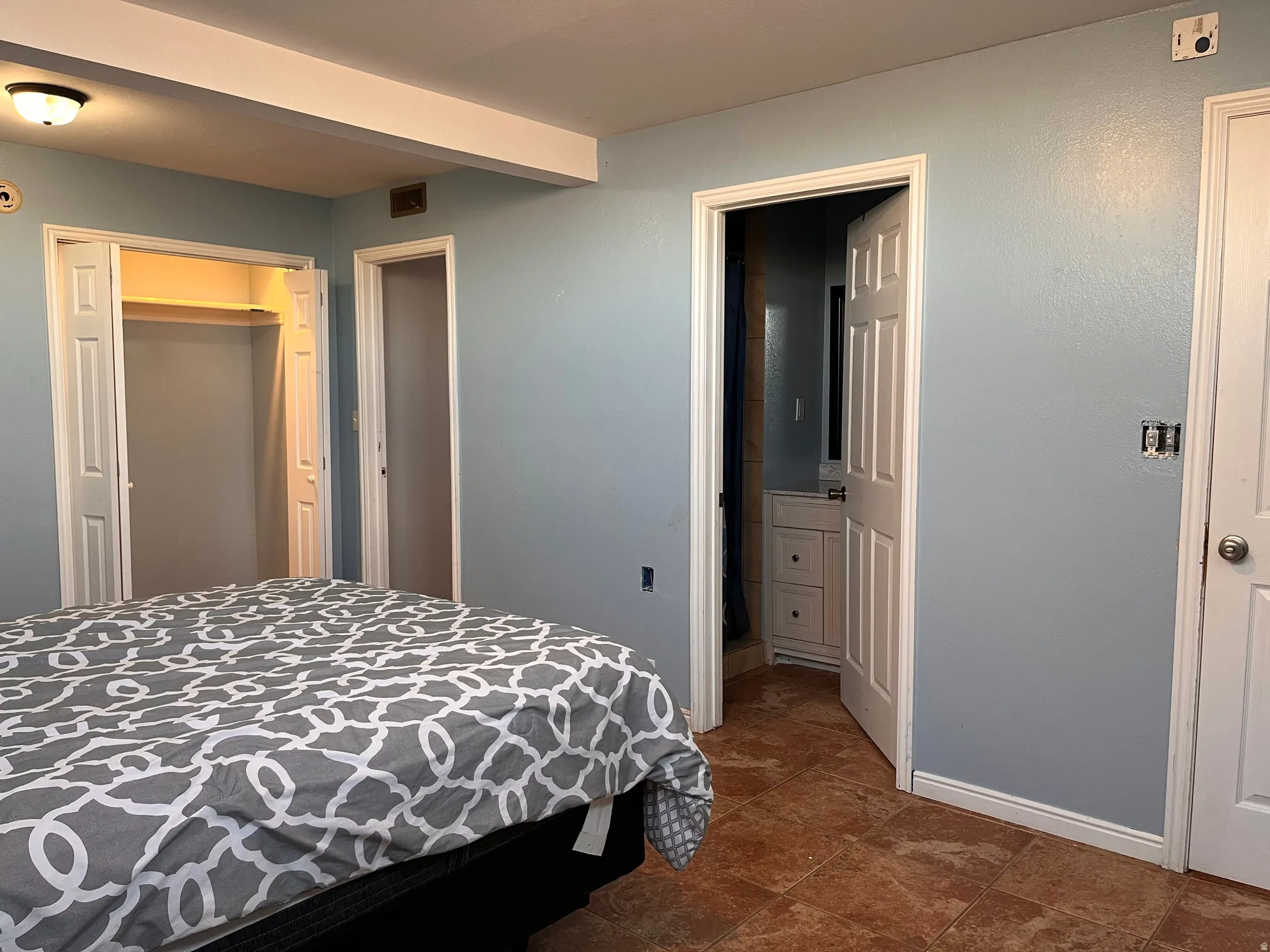 Bedroom featuring a closet and ensuite bath