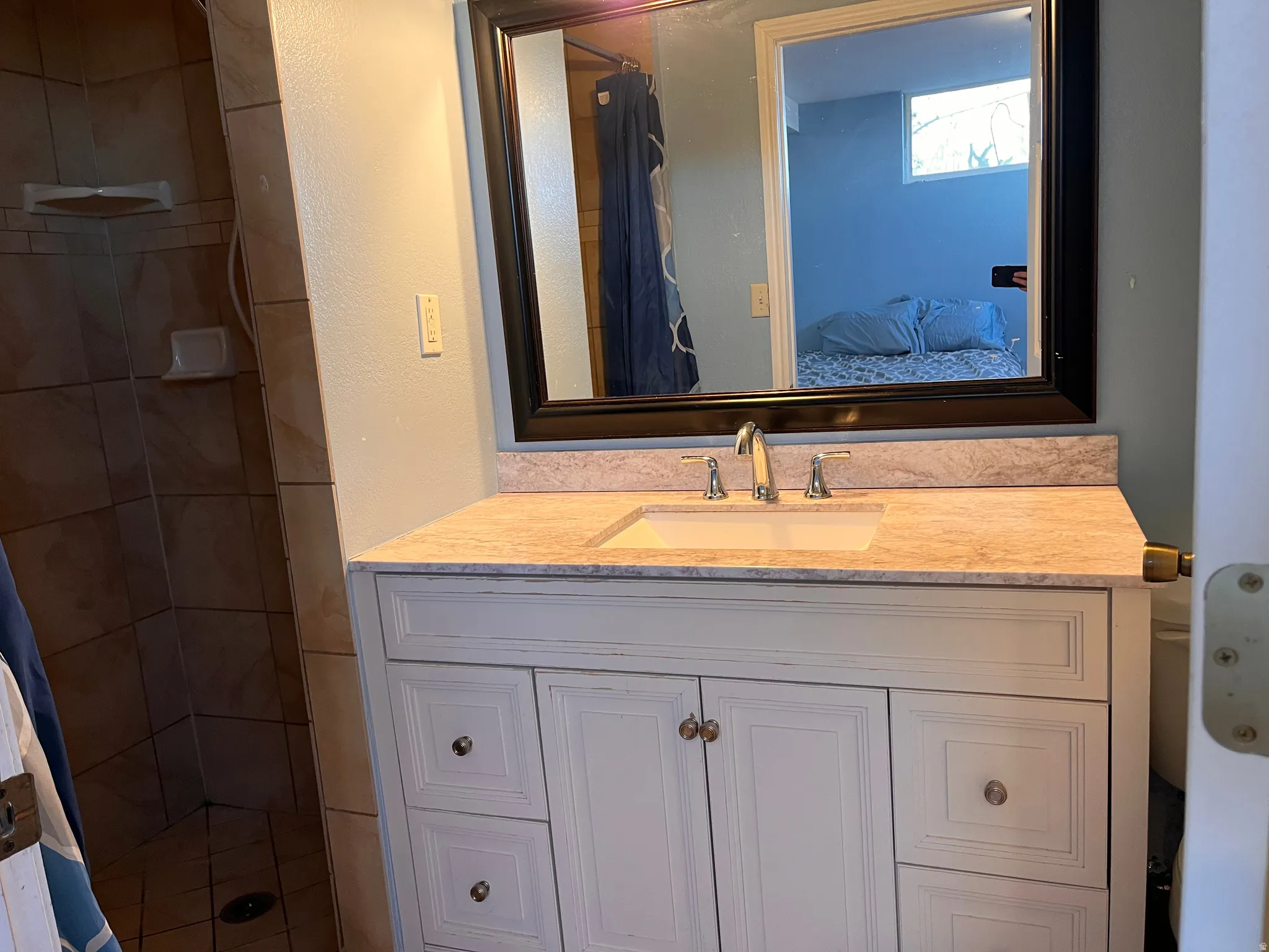 Bathroom featuring a shower stall, vanity, and ensuite bathroom