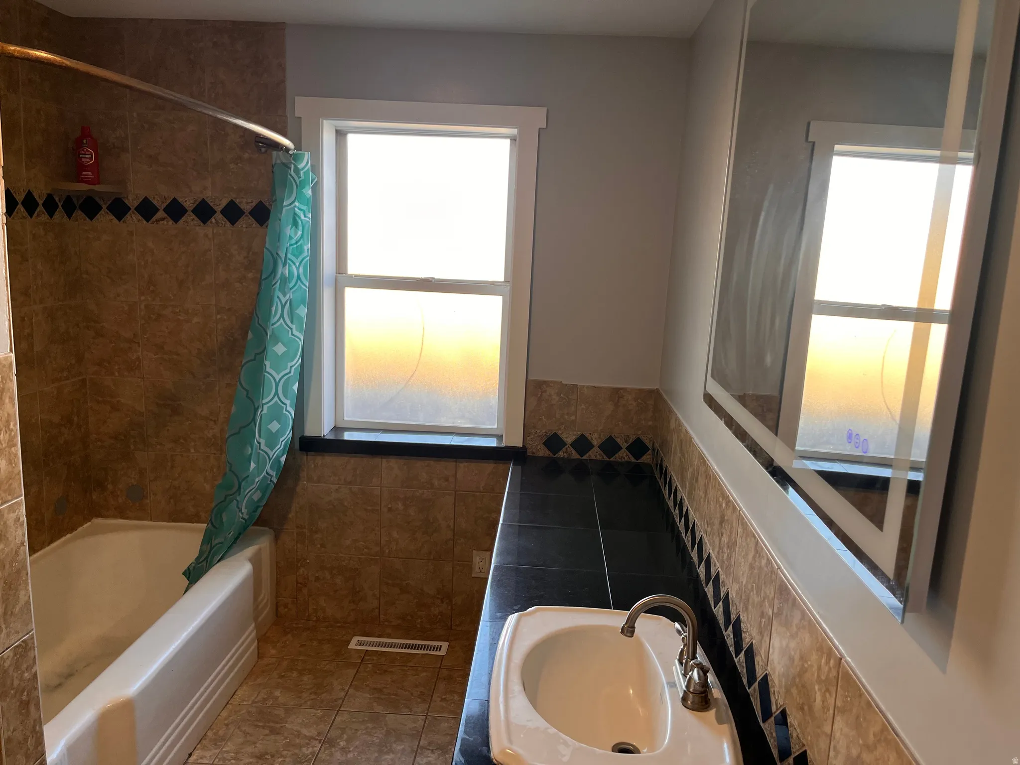 Full bath featuring shower / tub combo and vanity