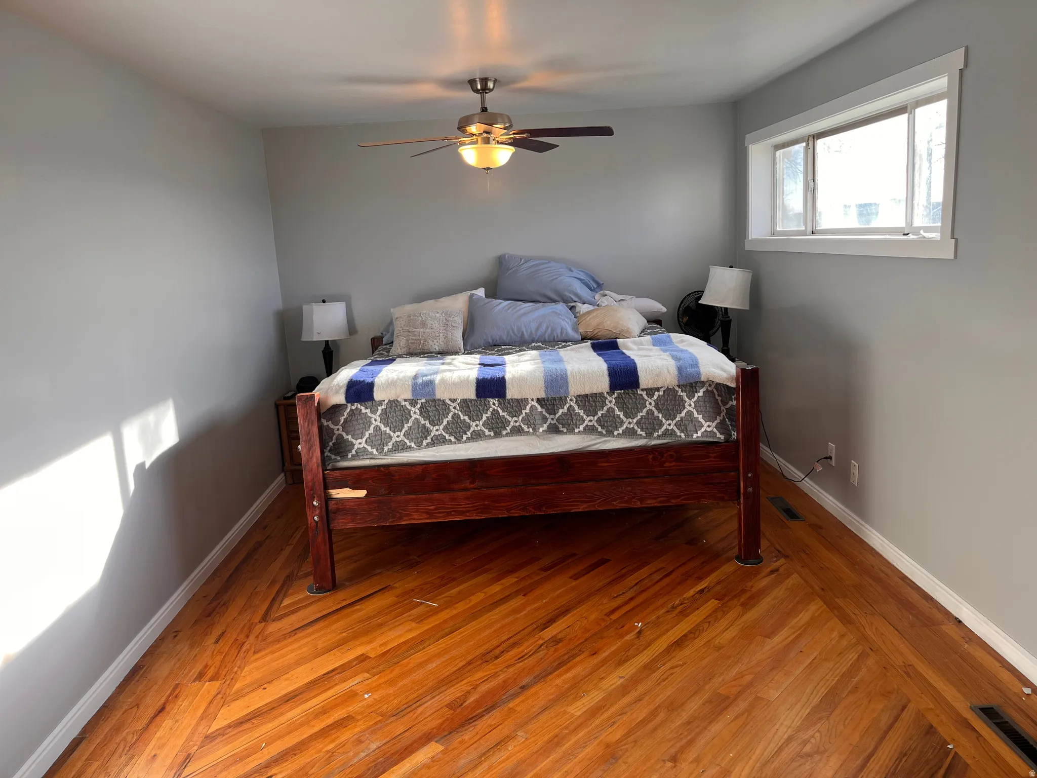 Bedroom with light wood finished floors and a ceiling fan
