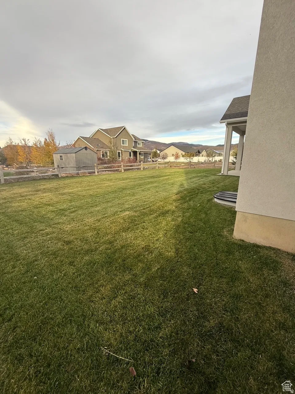 View of green lawn with a patio