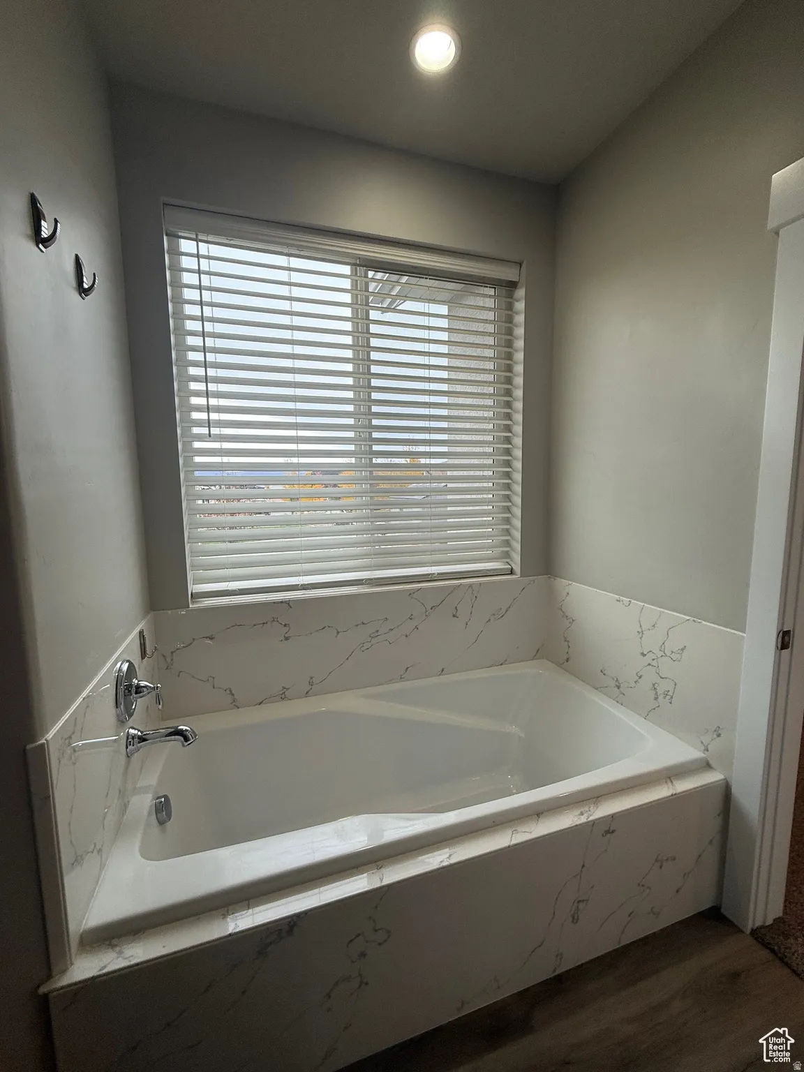 Full bath with a garden tub, recessed lighting, and dark wood-style flooring
