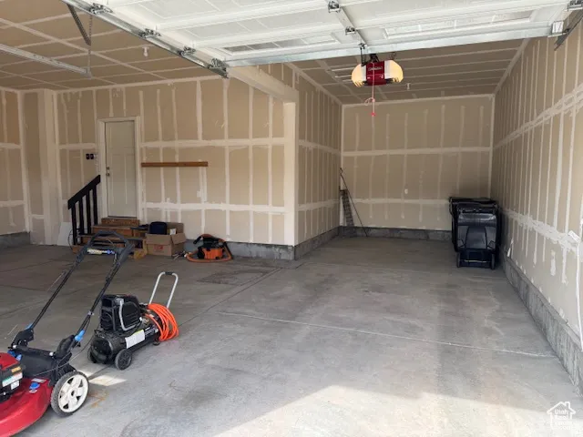 Garage featuring a garage door opener