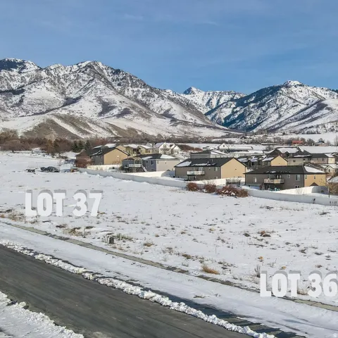 View of mountain backdrop featuring nearby suburban area