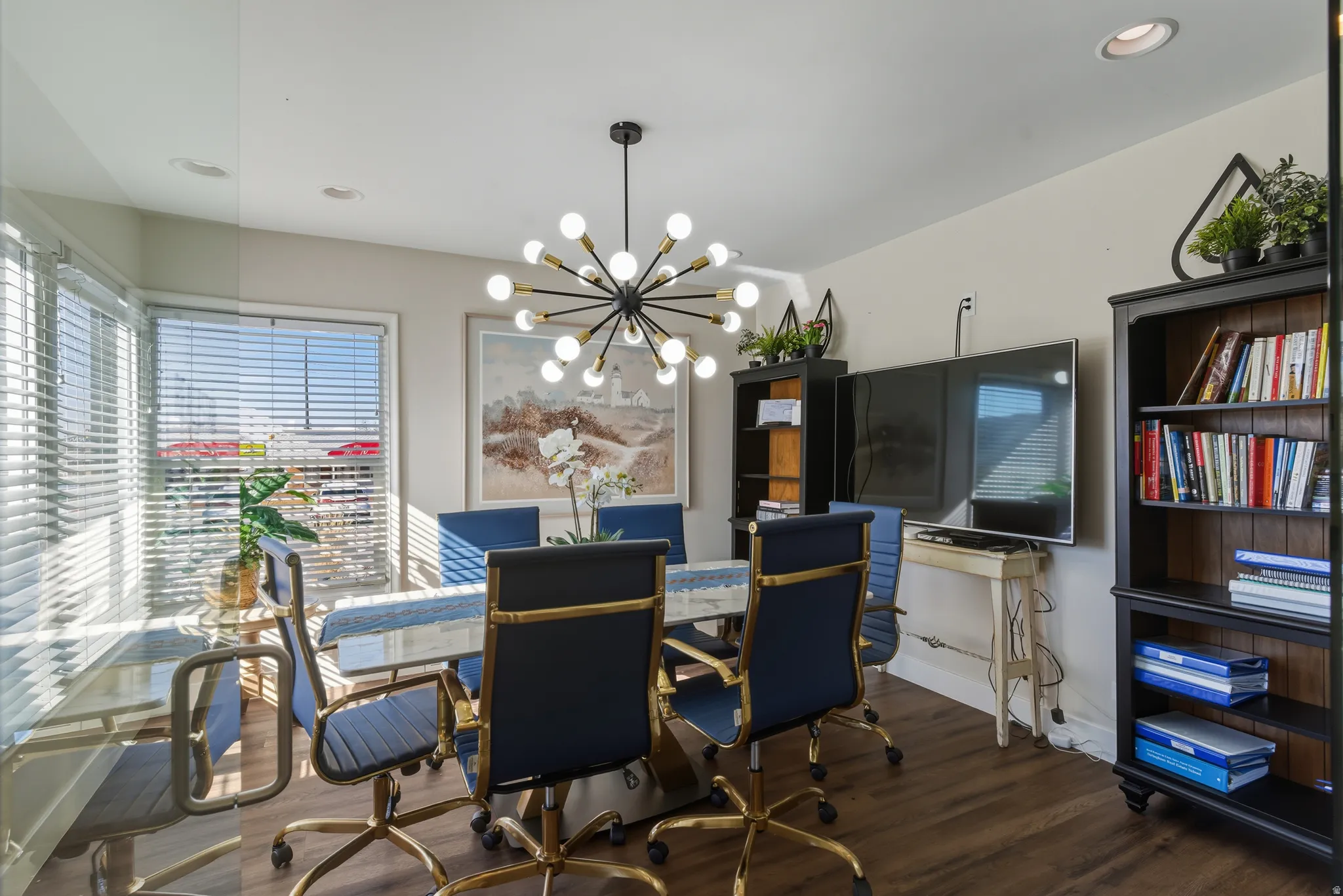 Dining room with hanging lights and dark wood-style floors