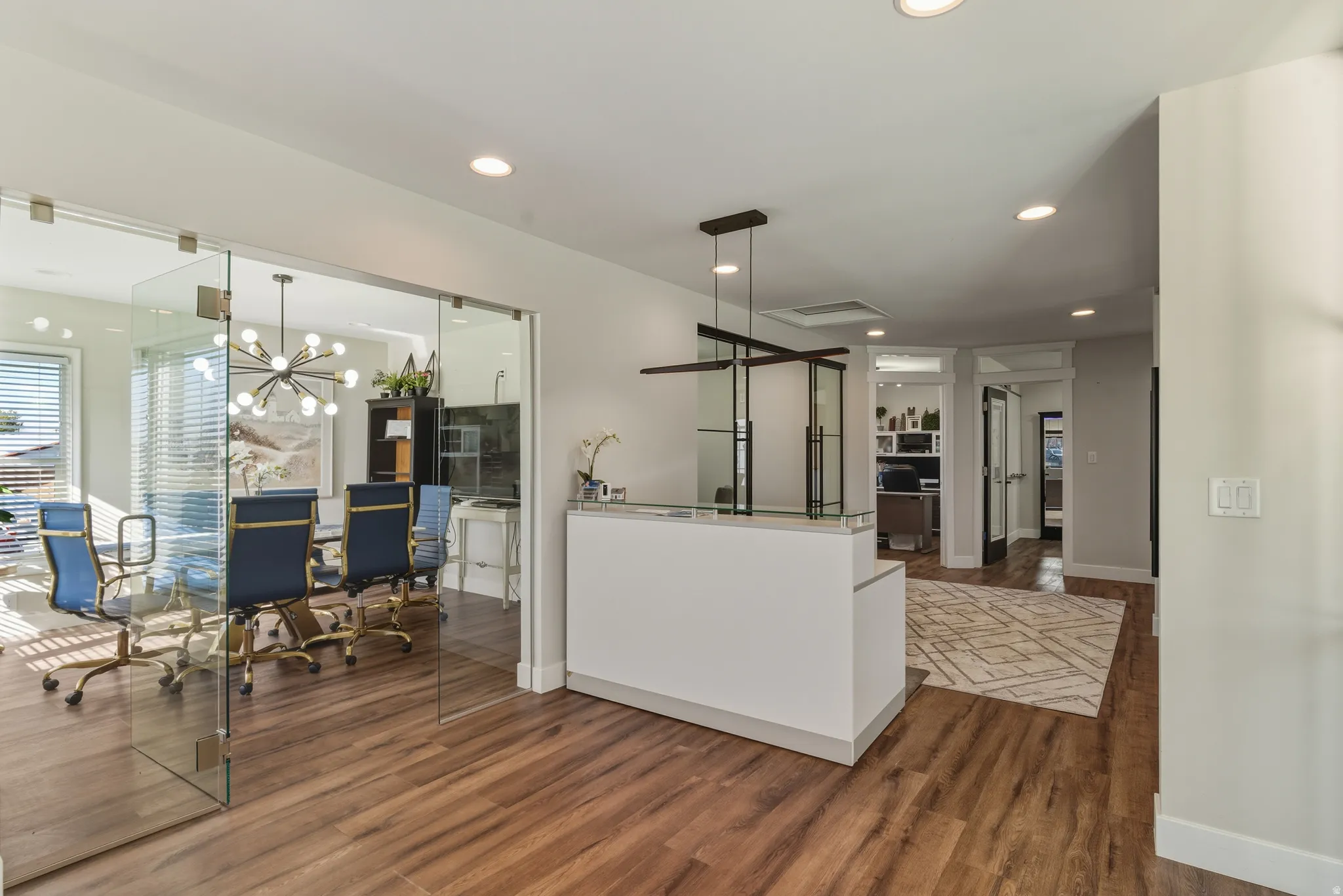 Kitchen with dark wood-style flooring and hanging lights