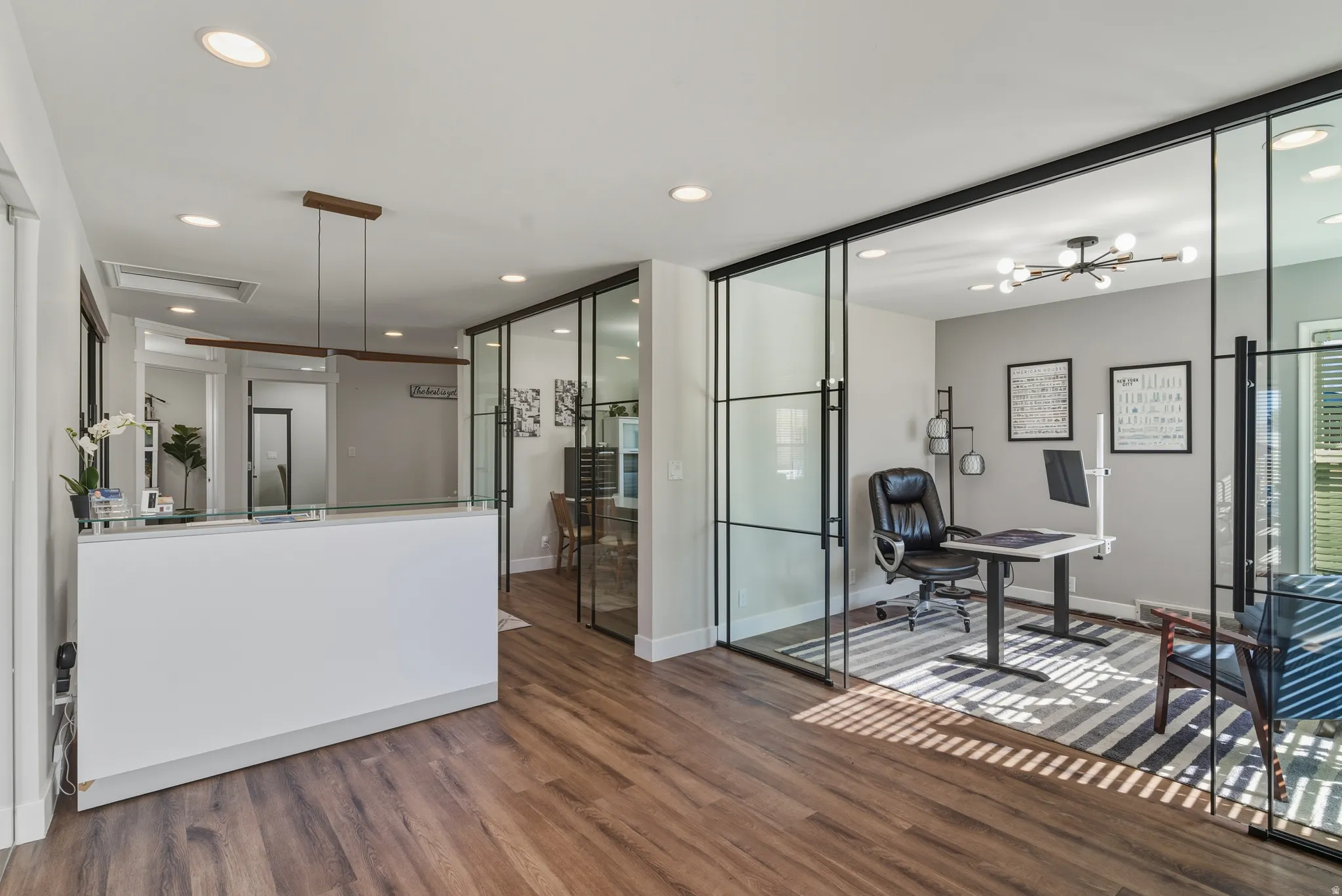 Office featuring dark wood-type flooring and recessed lighting