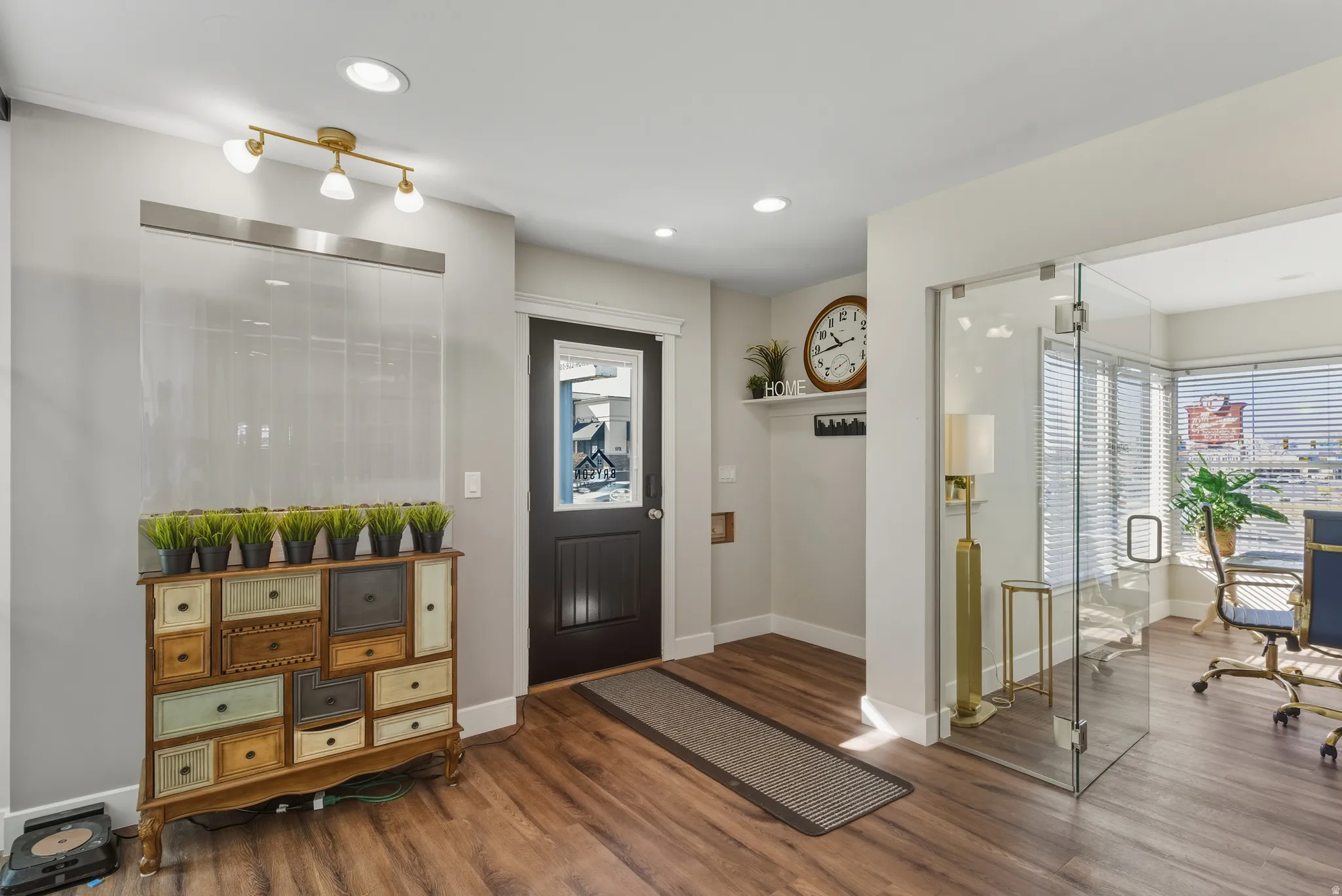 Foyer with dark wood-style floors and recessed lighting