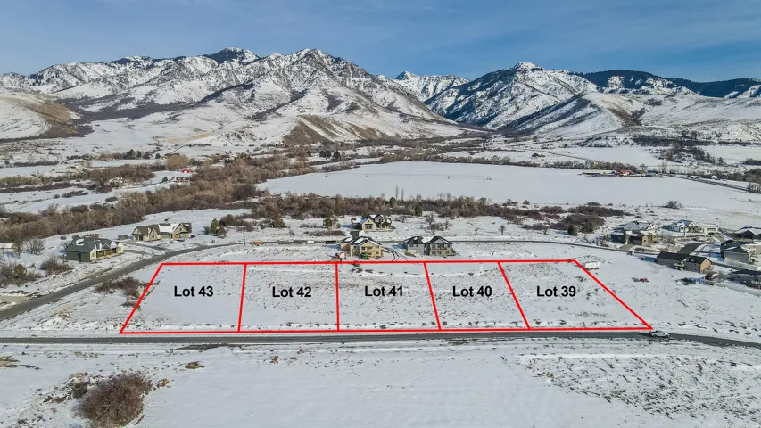 Snowy aerial view with property boundaries highlighted and a mountain view
