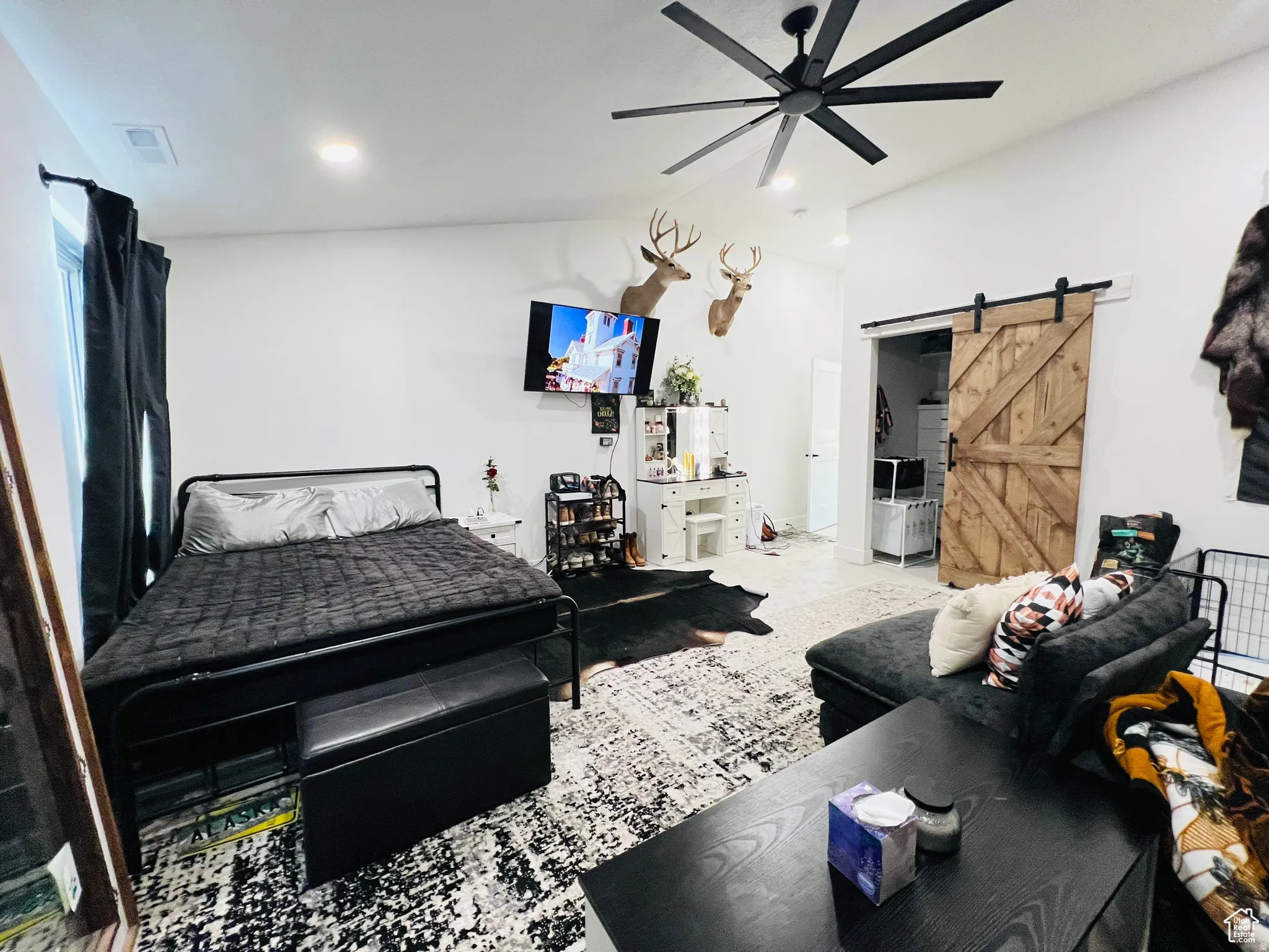 Bedroom featuring a barn door, ceiling fan, recessed lighting, and lofted ceiling
