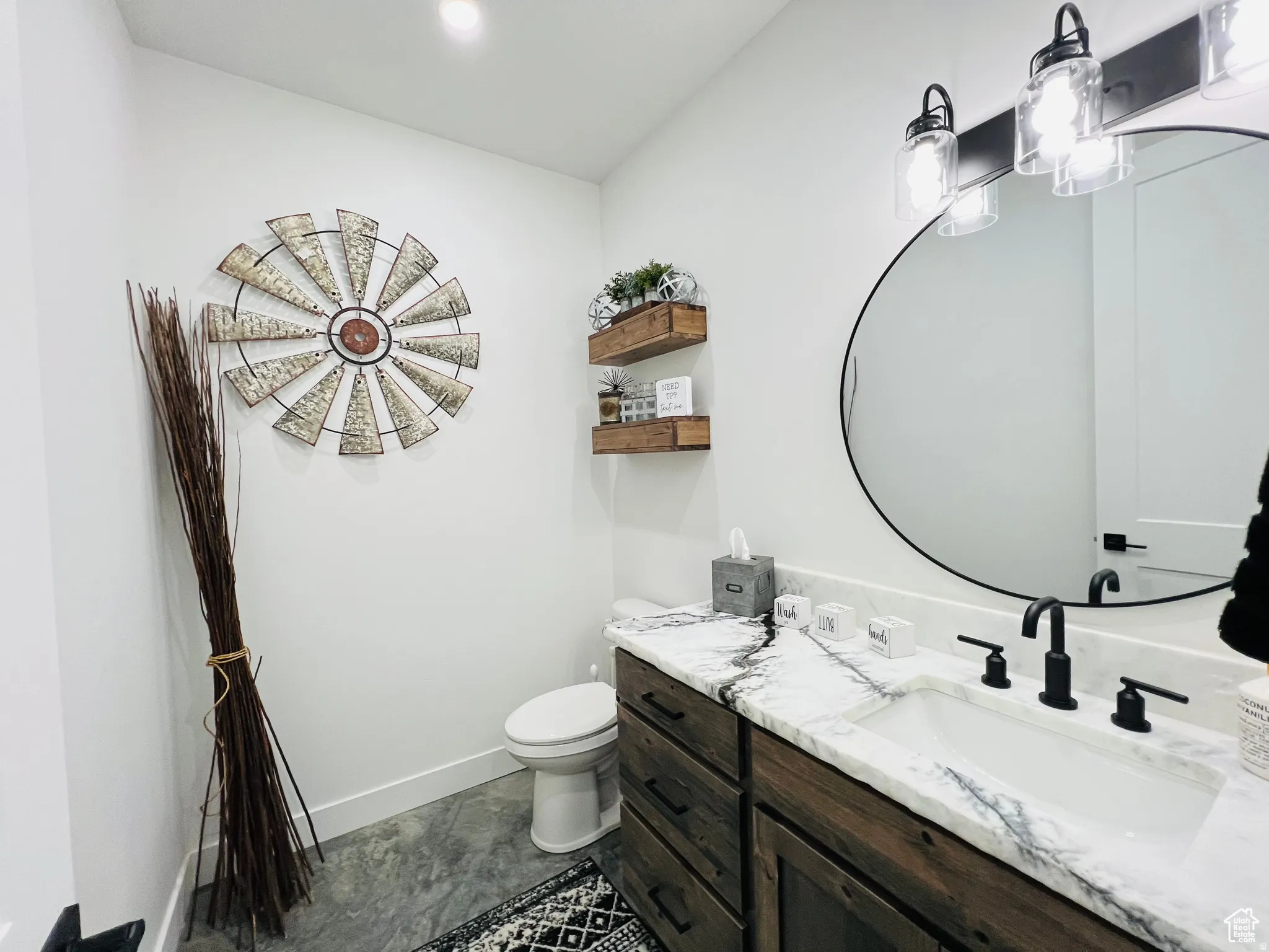 Half bathroom featuring vanity and toilet