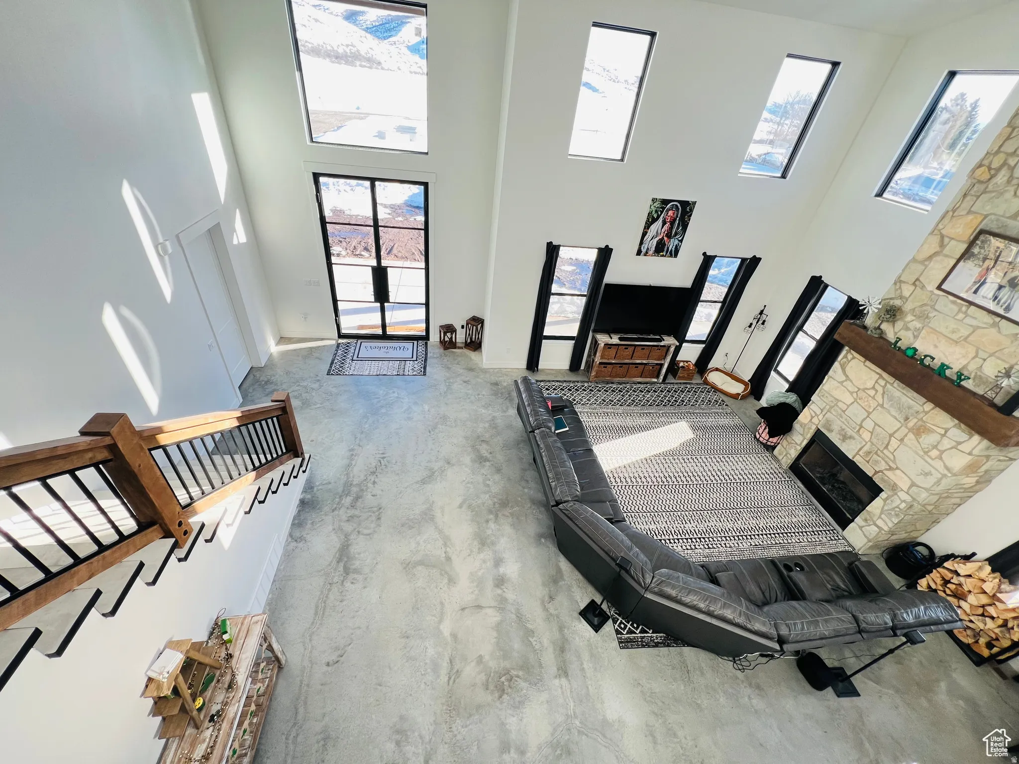 Living room featuring a high ceiling and a fireplace