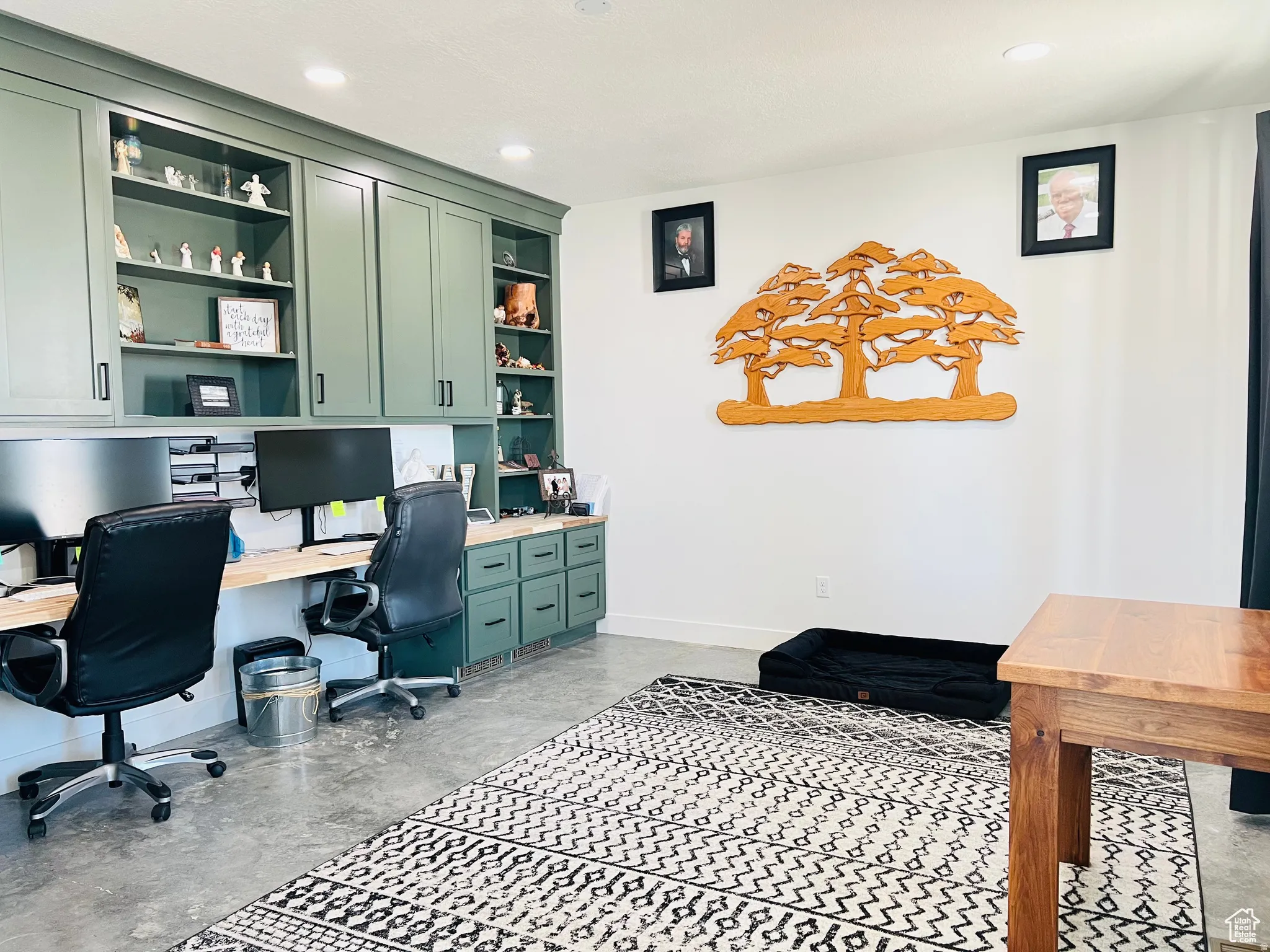 Office space featuring built in shelves, built in study area, recessed lighting, and concrete flooring
