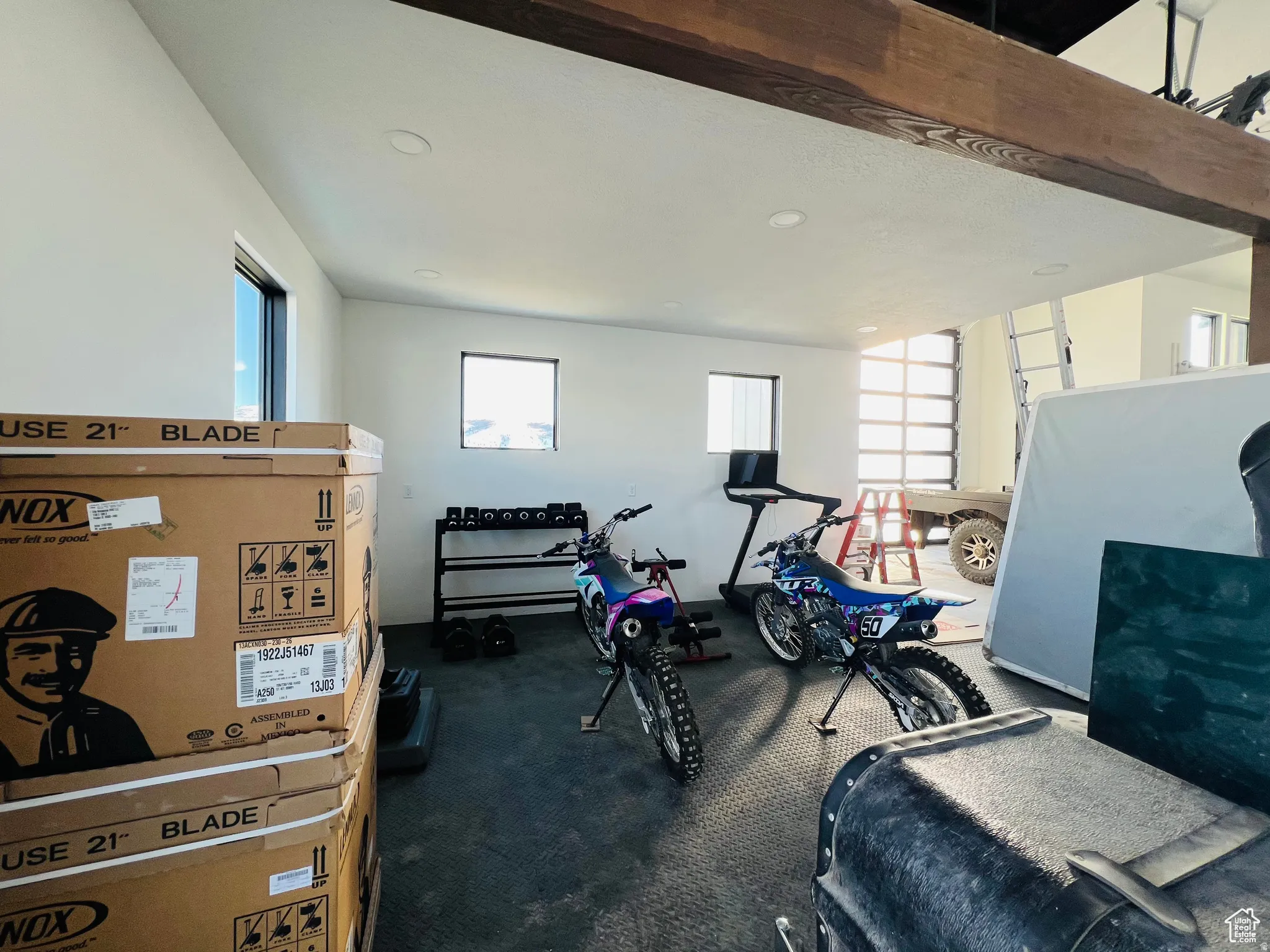 Workout room featuring plenty of natural light and dark colored carpet