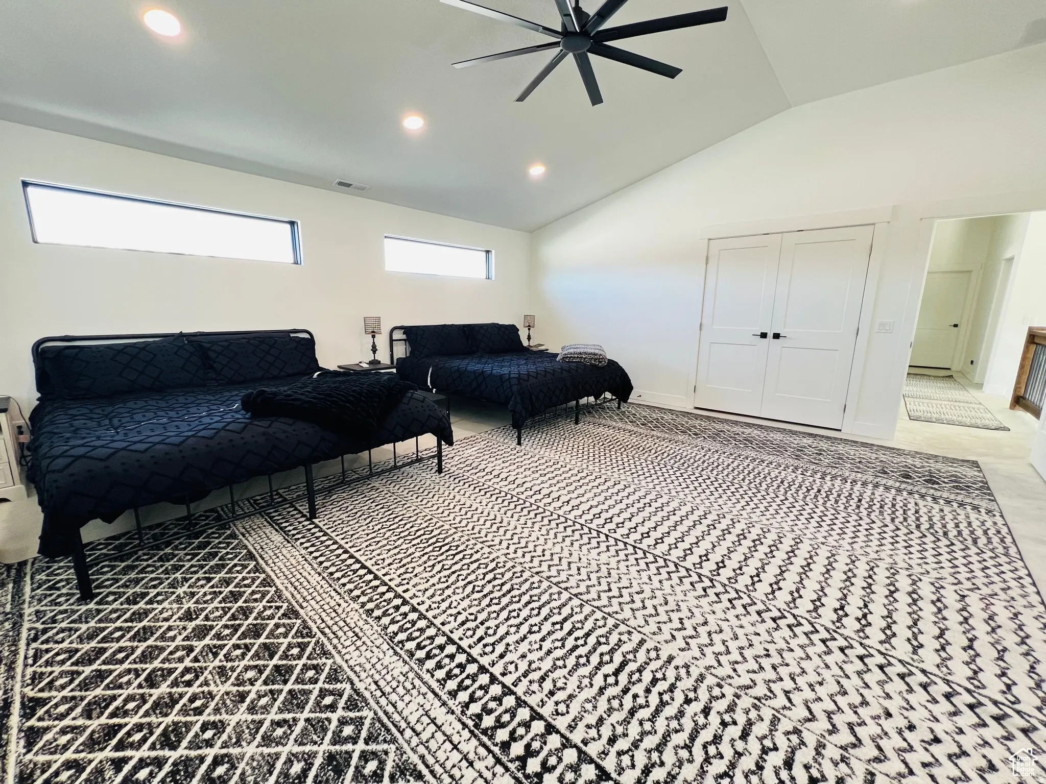 Living area featuring recessed lighting, a ceiling fan, and vaulted ceiling