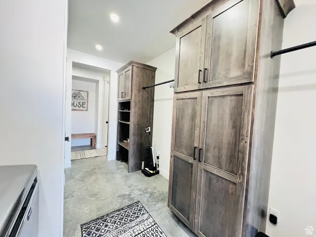Bathroom with unfinished concrete floors and recessed lighting