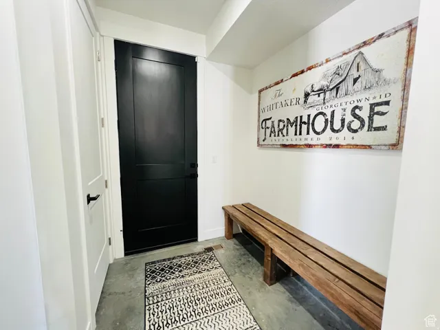 Mudroom with unfinished concrete floors