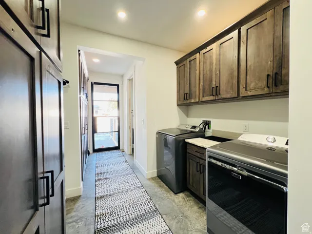 Laundry area featuring cabinet space, separate washer and dryer, and recessed lighting
