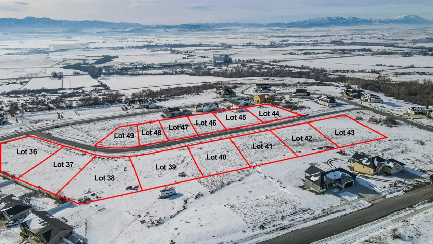 Snowy aerial view with property boundaries highlighted and a mountain view