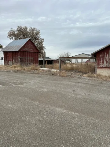 View of property exterior featuring an outdoor structure and a barn