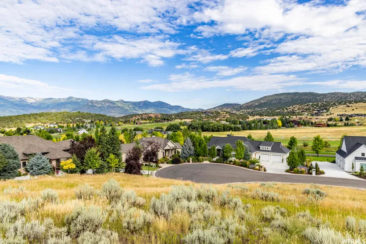 View of mountain backdrop featuring nearby suburban area