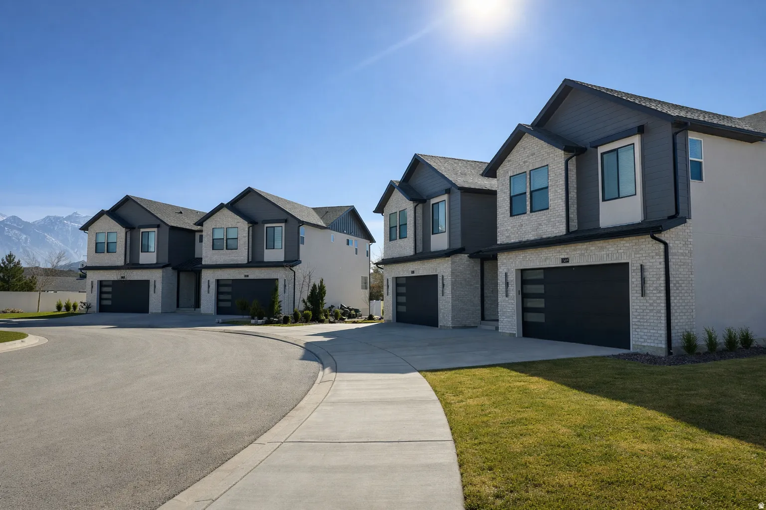 View of front of property with an attached garage, brick siding, concrete driveway, a front lawn, and a residential view