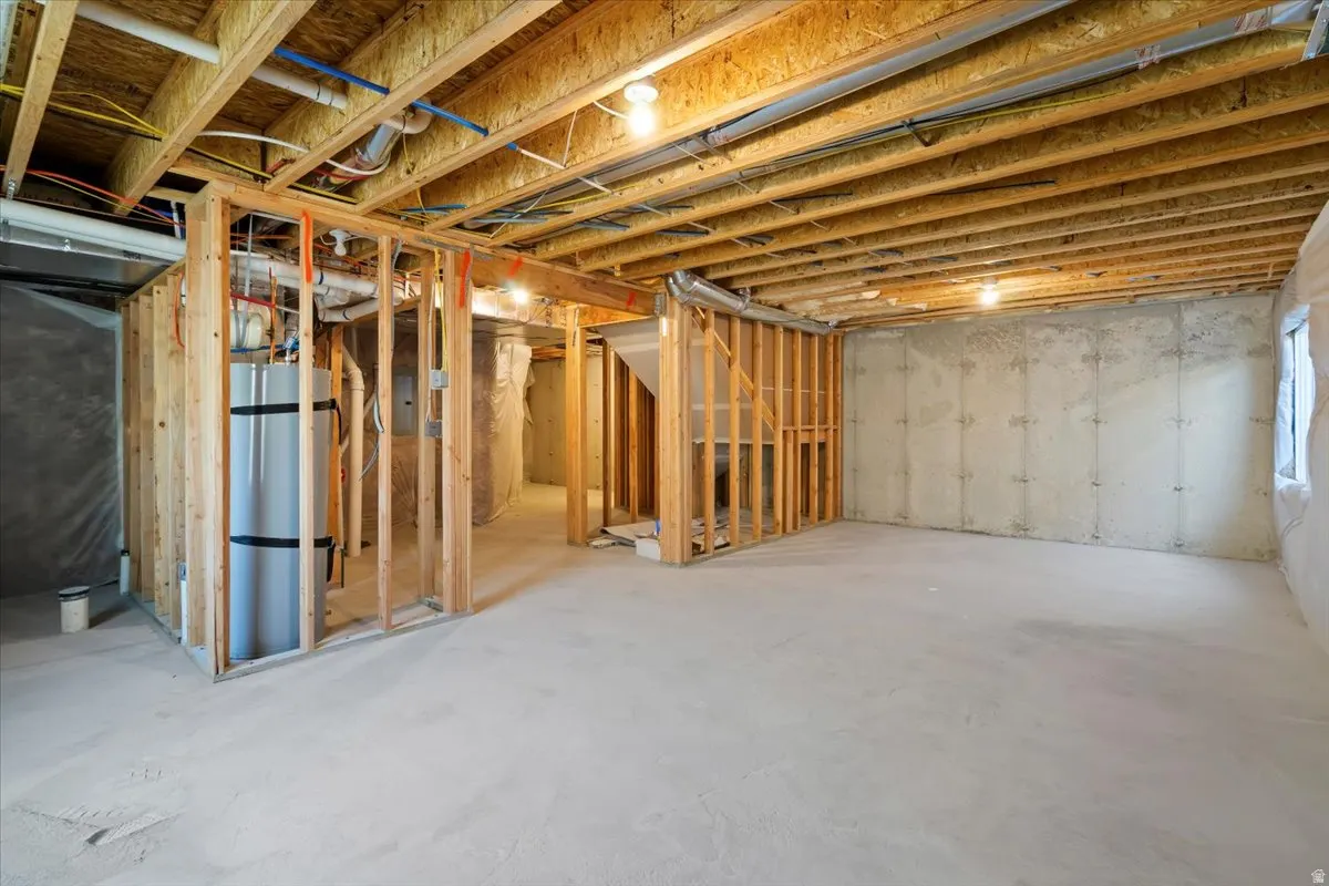 Unfinished basement featuring secured water heater