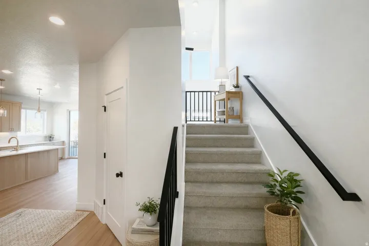 Stairway featuring wood finished floors, recessed lighting, and a textured ceiling