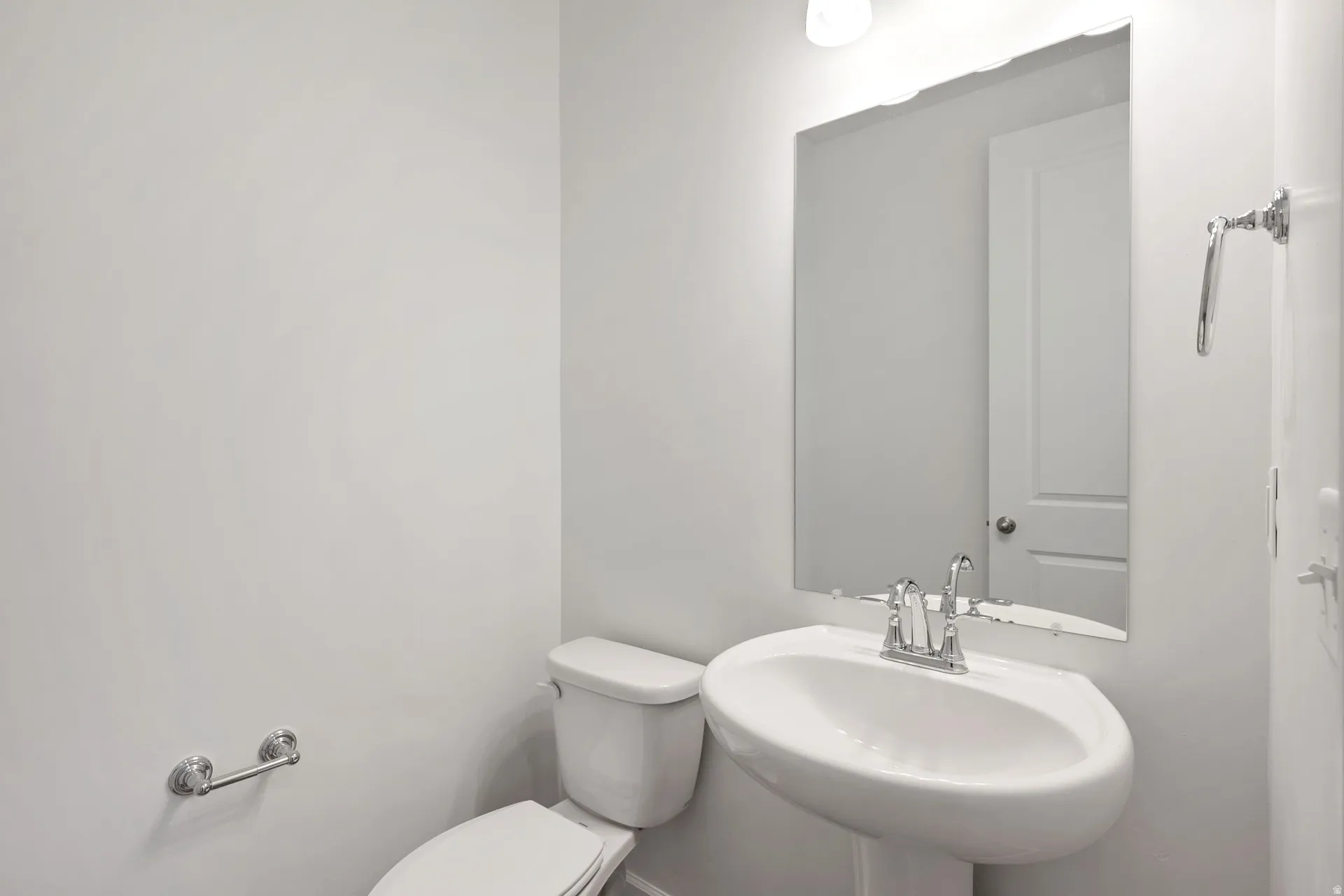 Half bathroom featuring toilet and a sink
