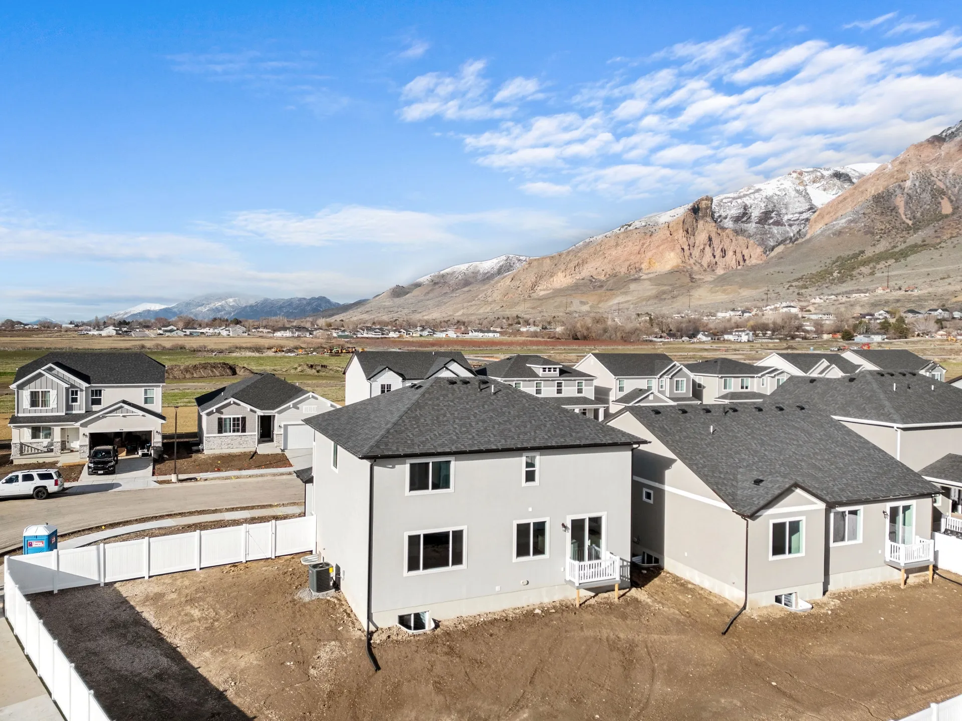 View of mountain backdrop featuring nearby suburban area