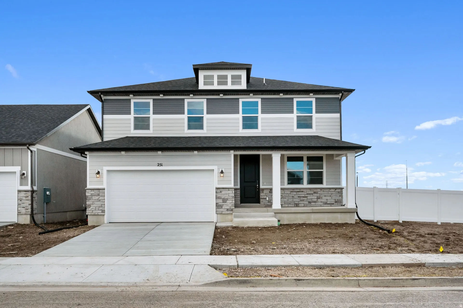 View of front of house featuring a porch, stone siding, concrete driveway, an attached garage, and roof with shingles