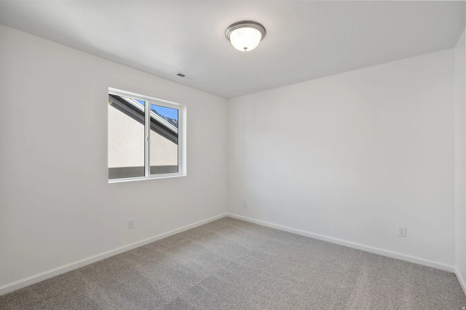Secondary bedroom featuring baseboards and light carpet