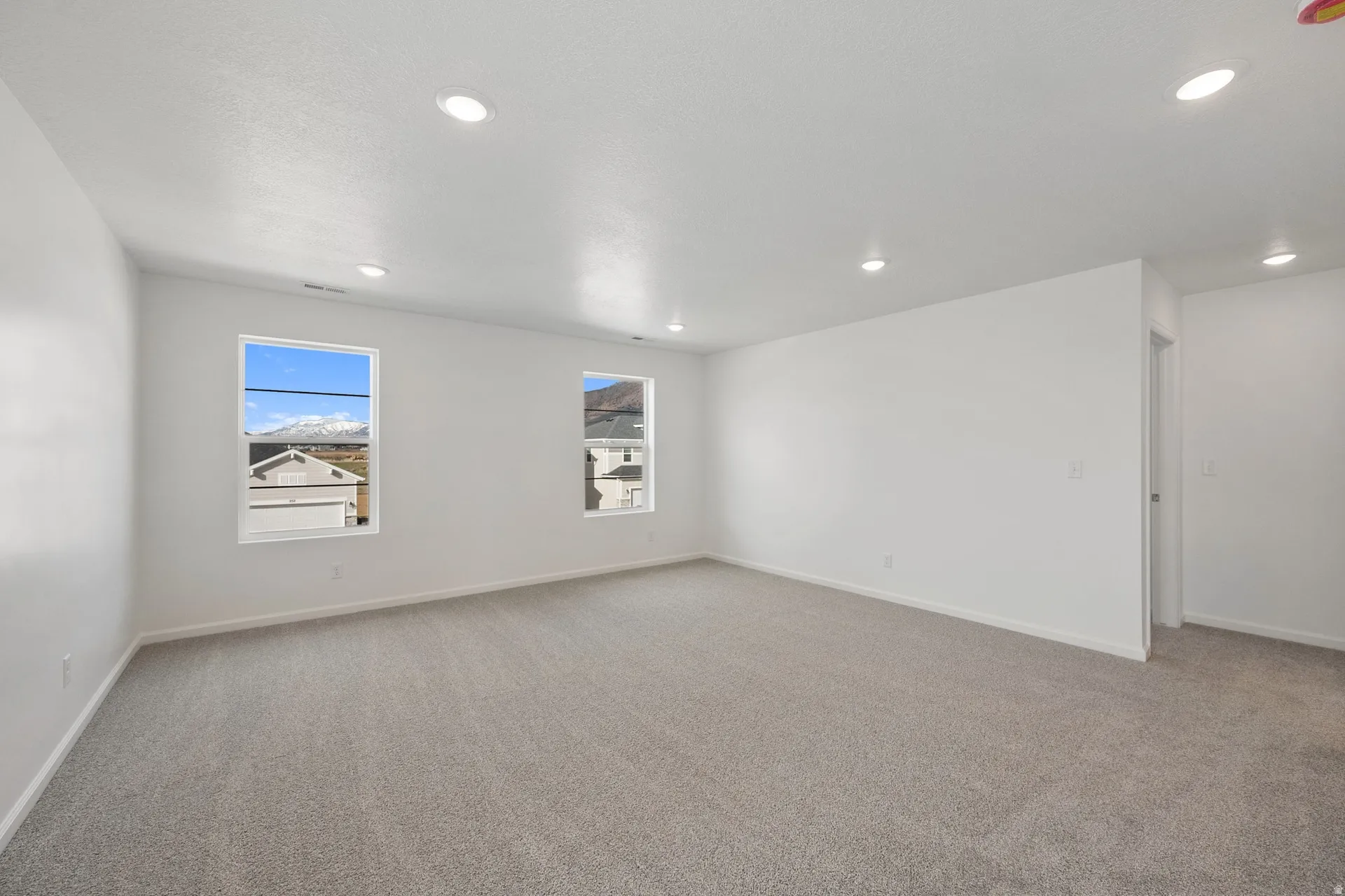 Upstairs loft featuring carpet and recessed lighting