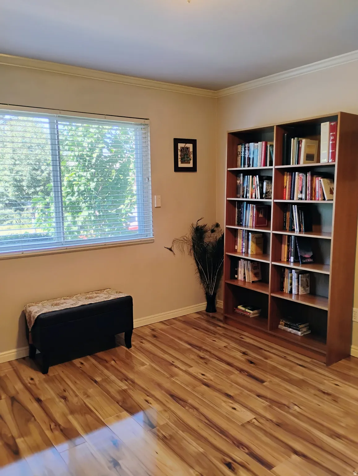Sitting room featuring light wood-type flooring and ornamental molding