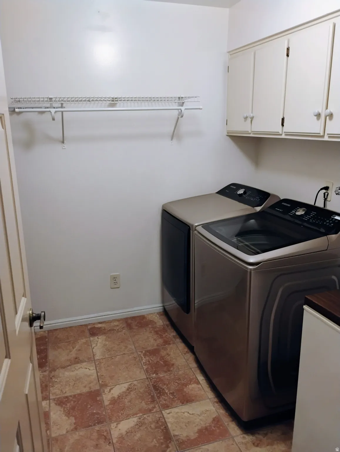 Laundry room featuring cabinet space and independent washer and dryer