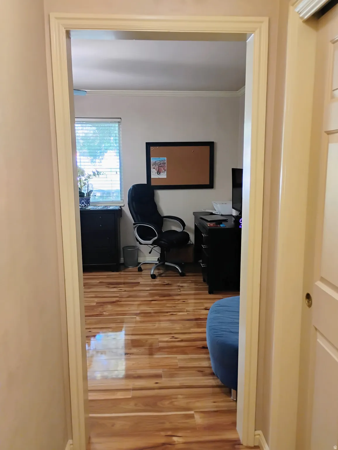 Office space featuring light wood finished floors and ornamental molding