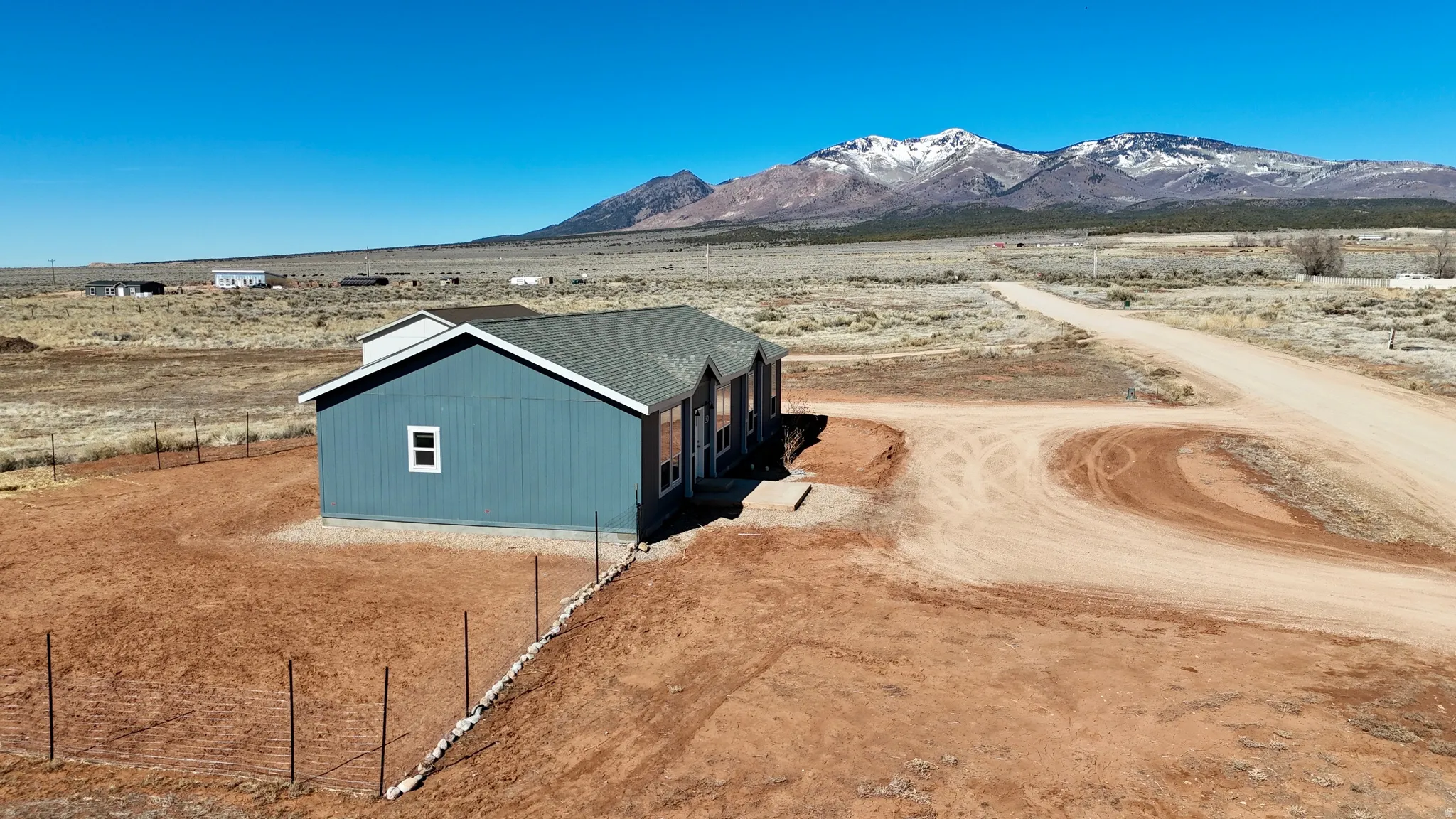 View of mountain backdrop with rural landscape and a desert landscape