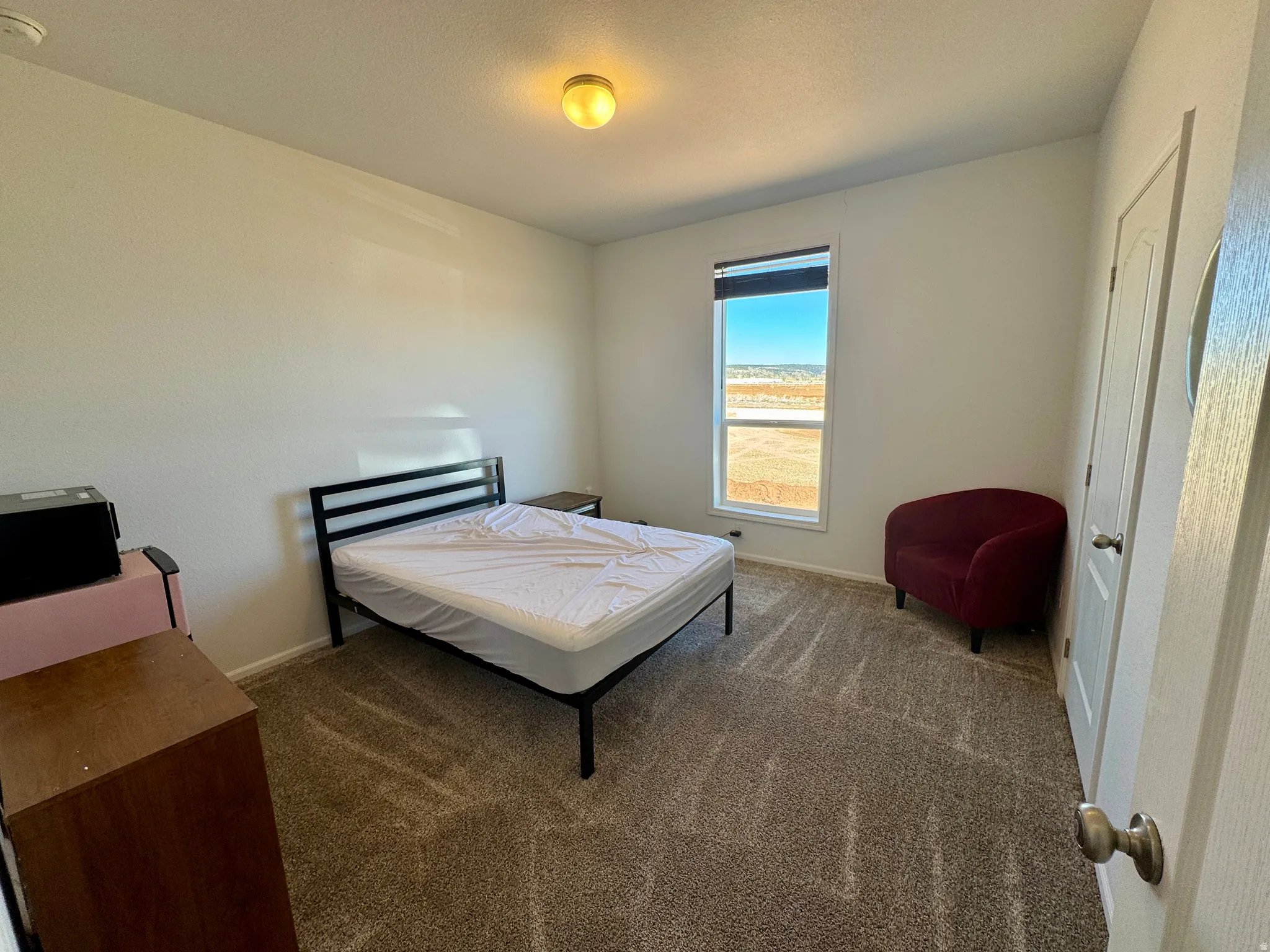 Carpeted bedroom with baseboards