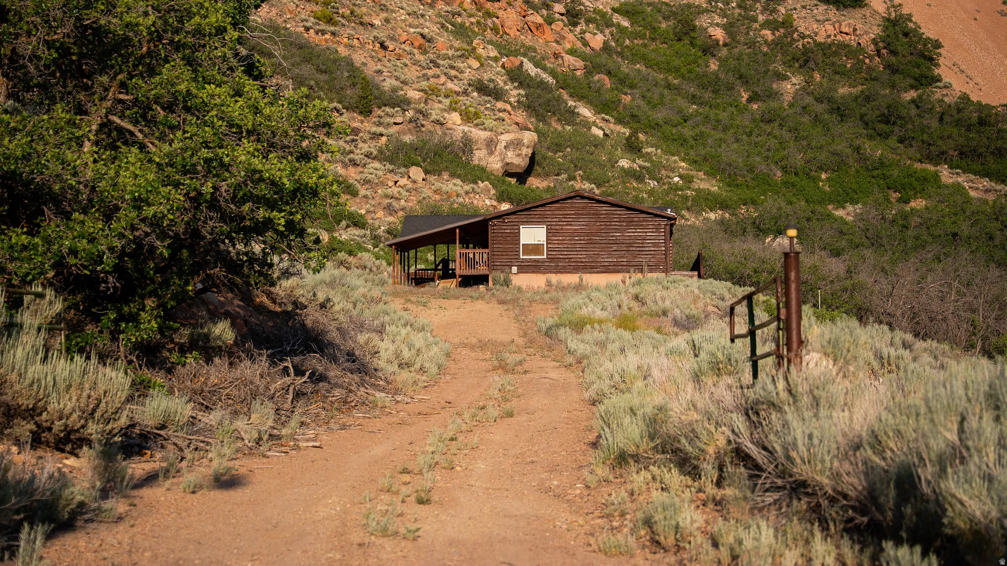 Rustic cabin with wood-paneled exterior and covered porch