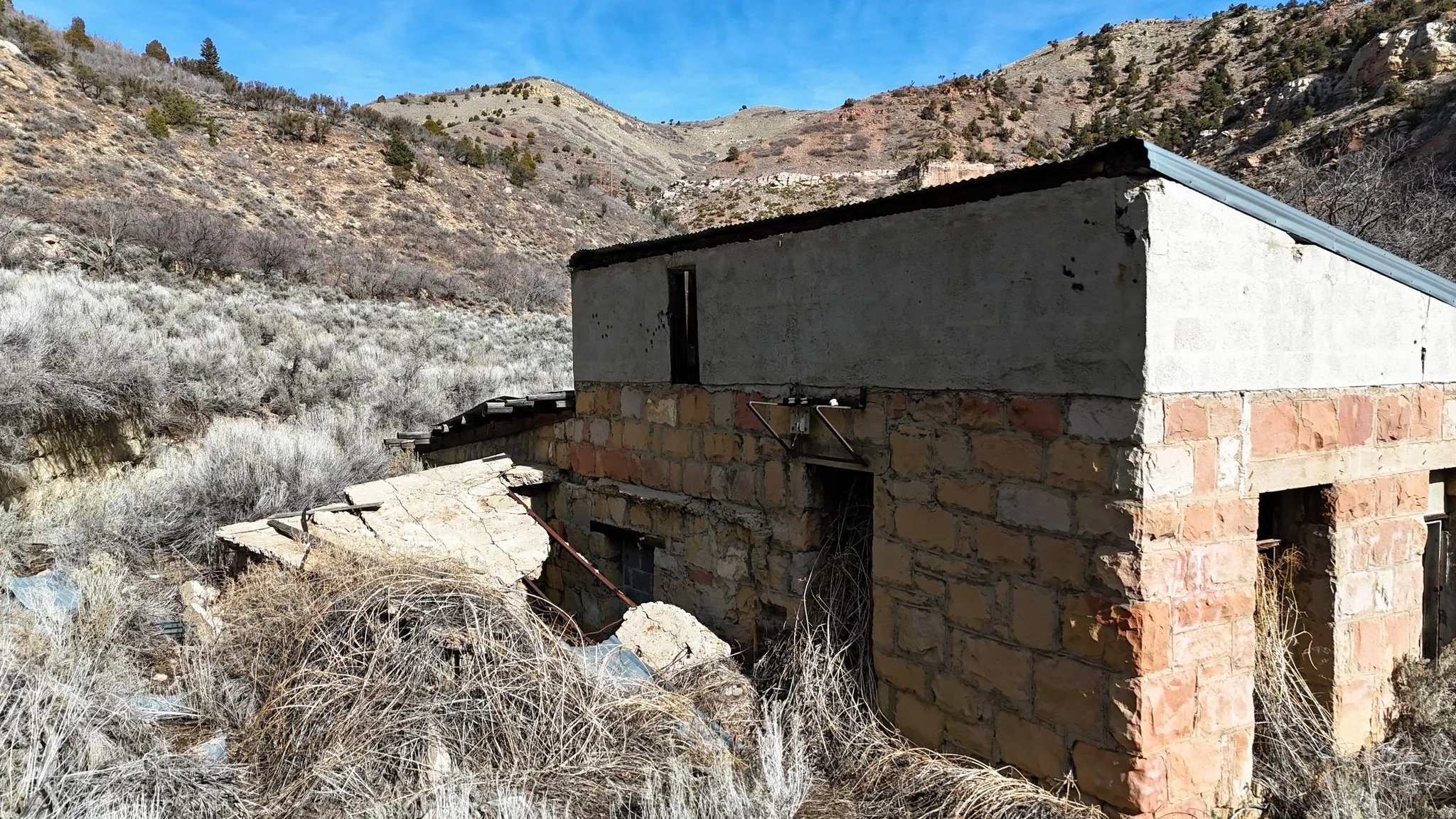 View of side of home with a mountain view and stone siding