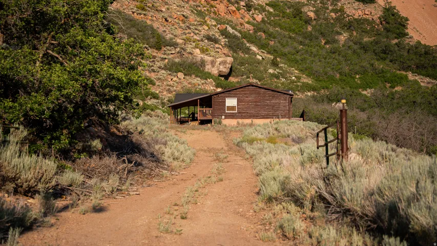 Rustic cabin with wood-paneled exterior and covered porch